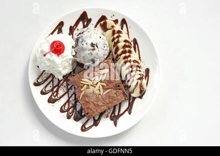 Schokoladen-Brownie mit Eis Bananencreme und Sahnehäubchen Stockfoto