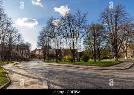 gepflasterte Straße schlängelt sich durch die Altstadt in der Nähe des Parks im späten Frühjahr Abend Stockfoto