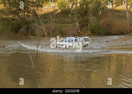 Allrad Fahrzeug mit Bugwelle weißen angeschnittene Ärmel Wasser machen gefährliche Überquerung der überfluteten Fluss in New South Wales zu schaffen. Australien Stockfoto