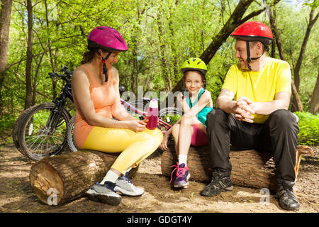 Familie entspannen nach dem Radfahren, sitzen auf den Protokollen Stockfoto