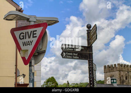 Beschilderung in der Innenstadt von Llandysul, Ceredigion Wales. Weichen Sie, Richtungen und die Kirche im Hintergrund. Stockfoto