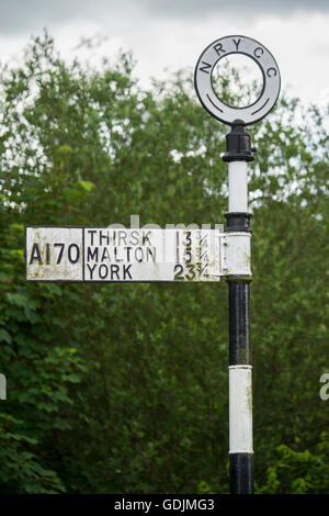 Helmsley, North Yorkshire - traditionelle Gusseisen Wegweiser auf den A170 Reisende in die richtige Richtung zeigt. Stockfoto