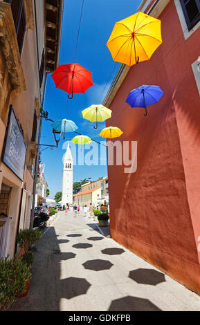 Offenen Sonnenschirme von Zeichenfolgen in der Straße von Novigrad hängen Stockfoto