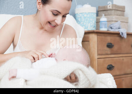 Mutter kitzeln Babyjungen, Lächeln Stockfoto