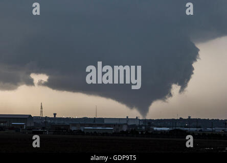 Ein Kegel Tornado aufsetzt aus einer sehr großen Wand Wolke droht es Dodge City, Kansas, USA Stockfoto