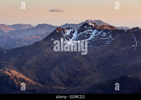 Die teilweise schneebedeckten Gipfel des Sattels beleuchtet gerade erst von der untergehenden Sonne, Glen Shiel Stockfoto