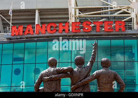 "Trinity United", eine Skulptur von Philip Jackson bei Manchester United Stadion Old Trafford, Manchester, England, UK. Stockfoto