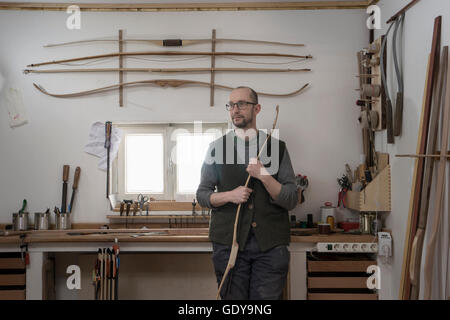 Männliche Bogenmacher Bogen und das Denken in Werkstatt, Bayern, Deutschland Stockfoto