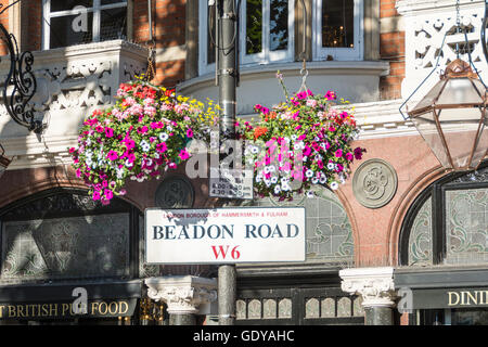 Eine bunte hängenden Korb und Straße unterzeichnen in Beadon Road, Hammersmith, London, W6, UK Stockfoto