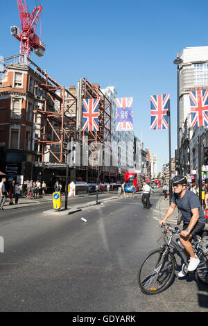 Union Jacks fliegen vor Centrepoint auf Londons Oxford Street, UK Stockfoto