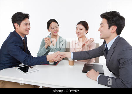 Porträt von zwei Lächelnde Geschäftsleute Händeschütteln mit einander von Angesicht zu Angesicht und zwei lächelnde Geschäftsfrauen Stockfoto