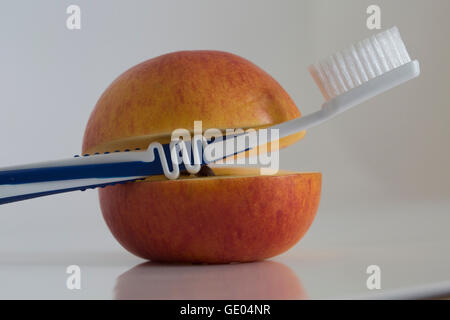 Nahaufnahme von Apple mit Zahnbürste Stockfoto