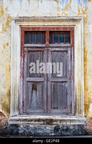 altes Holz Fenster an der Wand eines heruntergekommenen Altbaus Stockfoto