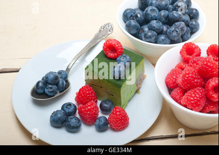 Grüner Tee Matcha Mousse Torte mit Himbeeren und Heidelbeeren an der Spitze Stockfoto