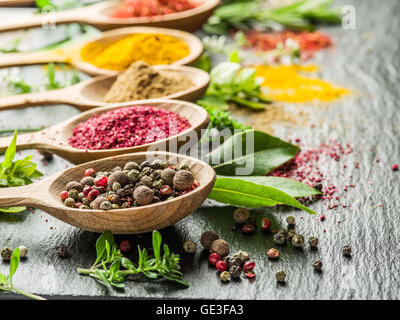 Auswahl an bunten Gewürzen in den Kochlöffel. Stockfoto