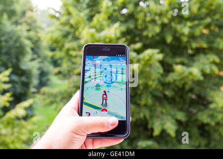 Apple iPhone6 Plus hielt in der einen Hand seinen Bildschirm mit Pokemon Go Anwendung zeigen. Stockfoto