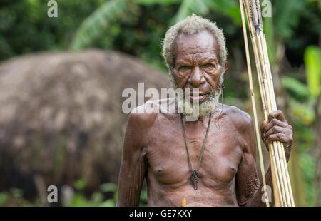 Ugem Dorf, Baliem-Tal, West-Papua, Indonesien - 13. Februar 2016: Dani Stamm Mann mit Pfeil und Bogen Stockfoto