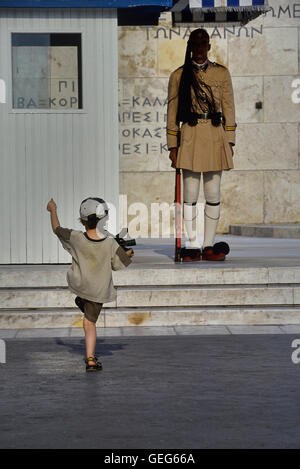 Evzone bewachen das Grab des unbekannten Soldaten in Athen von einem kleinen Jungen kopiert wird. Griechenland. Europa Stockfoto