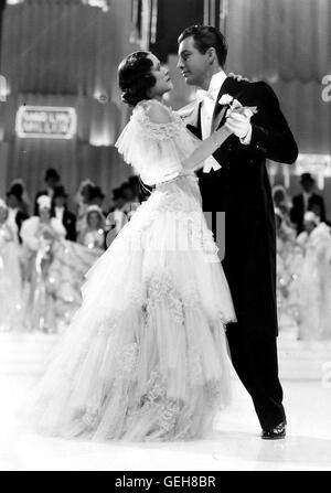 Eleanor Powell, Robert Taylor Der Broadway-Standardwerk Steve Raleigh (Robert Taylor) Geschäftführer Dringend Finanzielle Unterstuetzung Fuer Sein Neues Musical. Da Trifft es Sich Gut, dass. Showstar Sally (Eleanor Powell) Beim Pferderennen Caspers.    Lokalen Cap Stockfoto