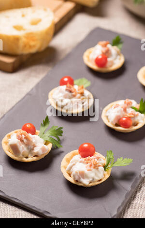 Kanapees, Vorspeise mit cremig-Hähnchen-Salat auf dem Schiefer Silbertablett serviert Stockfoto