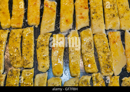 Rohteig gesalzener Käse Blätterteig-sticks mit Pfeffer und provenzalischen Kräutern Closeup auf Backblech Stockfoto