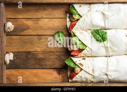 Gesunden Mittagssnack. Tortilla wraps mit gegrilltem Hühnerfilet und frischem Gemüse Stockfoto