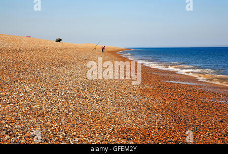 Ein Blick auf zwei Angler, die aus den Kiesstrand an der North Norfolk Küste Salthouse, Norfolk, England, Vereinigtes Königreich. Stockfoto