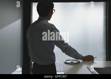 Japanischer Geschäftsmann im Raucherzimmer Stockfoto