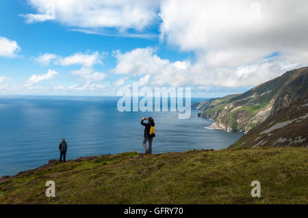 Touristen fotografieren am Slieve League Klippen in der Nähe von Teelin, County Donegal, Irland auf dem Wilden Atlantik Weg Stockfoto