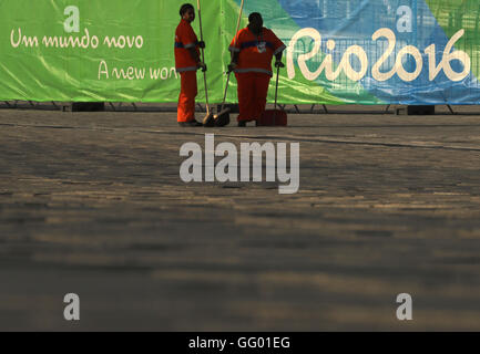 Rio De Janeiro, Brasilien. 1. August 2016. Reiniger arbeitet vor einem Zaun mit dem Rio 2016-Logo im Olympic Park Barra vor den Rio Olympischen Spielen 2016 in Rio De Janeiro, Brasilien, 1. August 2016. Olympische Spiele 2016 in Rio statt von 05 bis 21 August. Foto: Michael Kappeler/Dpa/Alamy Live News Stockfoto