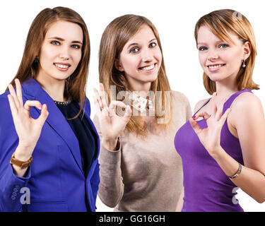 Drei junge Frauen zeigen OK Sign. Stockfoto