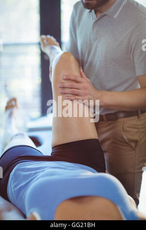 Physiotherapeut und Bein massage mit einer Frau Stockfoto