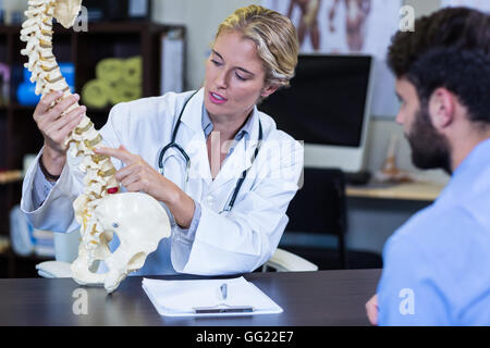 Physiotherapeut, Patienten zu erklären, Wirbelsäule Modell Stockfoto