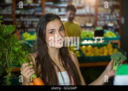 Frau, Karotten und Brokkoli im Supermarkt zu kaufen Stockfoto