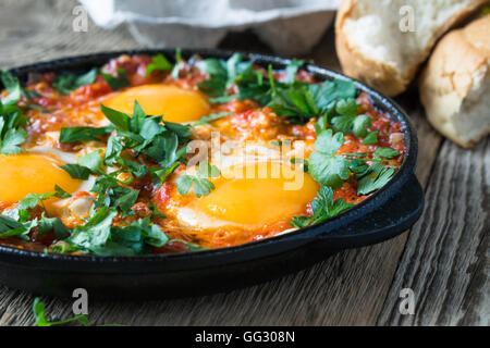 Hausgemachte Eierspeise mit Tomatensauce serviert in der gusseisernen Pfanne, Chakchouka, Hausmannskost Stockfoto