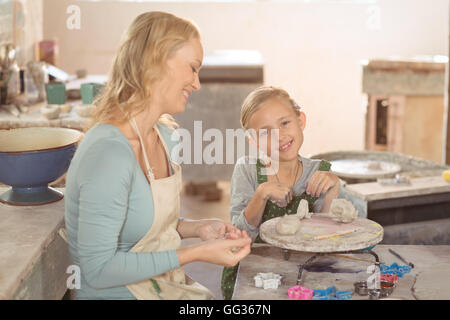 Weibliche Potter und Mädchen arbeiten in Werkstatt Stockfoto