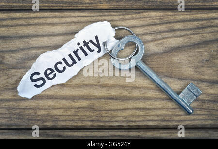 Schlüssel mit Meldung Sicherheit auf Holztisch Stockfoto