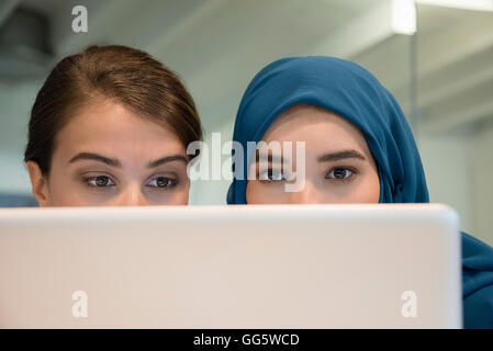 Nahaufnahme von zwei weiblichen Kollegen arbeiten auf einem laptop Stockfoto