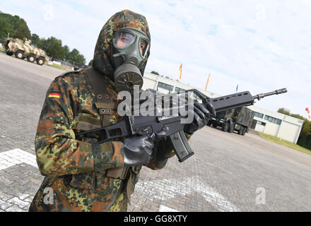 Bruchsal, Deutschland. 10. August 2016. Ein Soldat der Bundeswehr die ABC Verteidigung Bataillon 750 tragen spezielle schützende Kleidung und halten einen Heckler und Koch G36 Angriff Gewehr in General-Dr.Speidel-Kaserne in Bruchsal, Deutschland, 10. August 2016. Foto: Uli Deck/Dpa/Alamy Live News Stockfoto