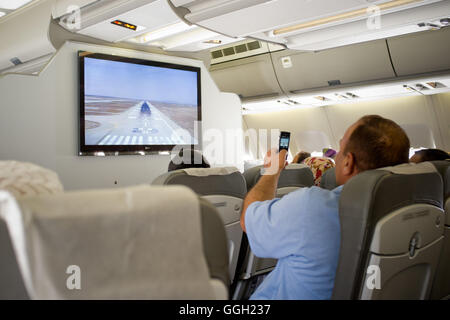 Ein Mann nimmt Bilder in einer iranischen Mahan Air-Ebene bei der bevorstehenden Landung am Flughafen Teheran (Iran). Jordi Boixareu © Stockfoto