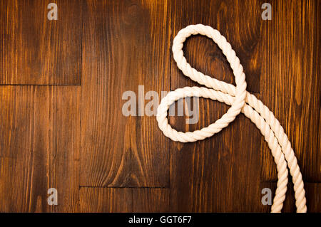 Jute Seil in Herzform auf hölzernen Hintergrund Stockfoto