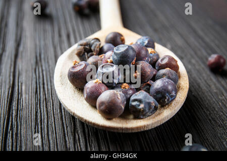 Wacholderbeeren auf alten Holzlöffel Stockfoto