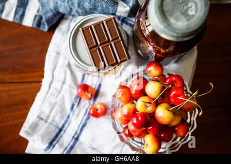 Rainier Kirschen, Schokolade und Gelee in eine rustikale Küche-Einstellung. Stockfoto