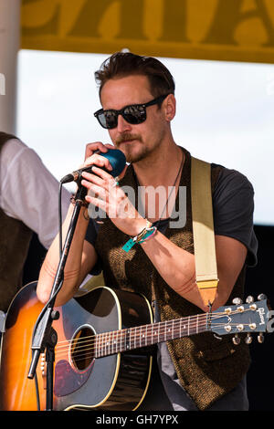 Broadstairs folk Woche. Junger Mann folk Sänger Gitarrist, trug eine dunkle Sonnenbrille, die im Musikpavillon. Nahaufnahme von Sänger und Gitarre. Stockfoto