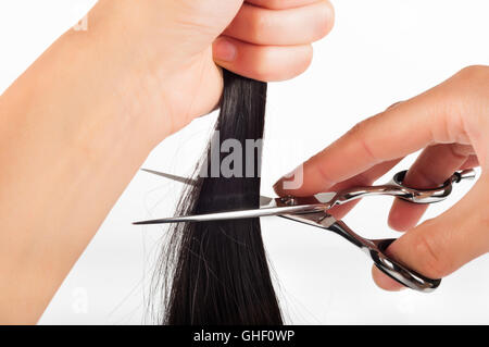 Schere und Haare Stockfoto