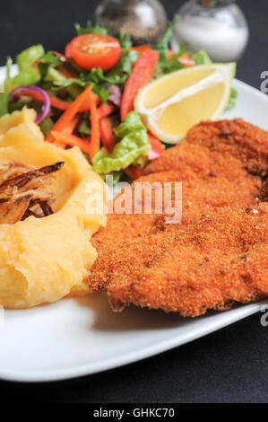 Panierte Hähnchen Schnitzel mit Kartoffelpüree und Salat Stockfoto