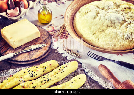 Vintage getönten Brot-Sticks und Hefeteig fertig zum Backen. Stockfoto