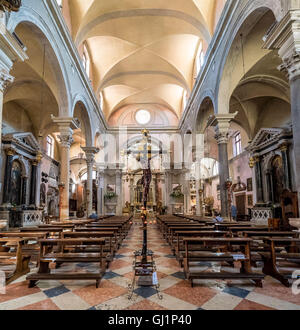 Holzbänke, Kruzifix und Gang der Chiesa di San Canciano in Cannaregio Bezirk von Venedig. Italien Stockfoto