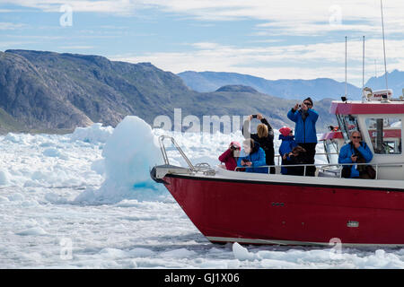 Touristen auf einer roten Bootstour umgeben von Meereis im Tunulliarfik-Fjord fotografieren Qooroq icefjord im Sommer 2016. Narsarsuaq Südgrönland Stockfoto