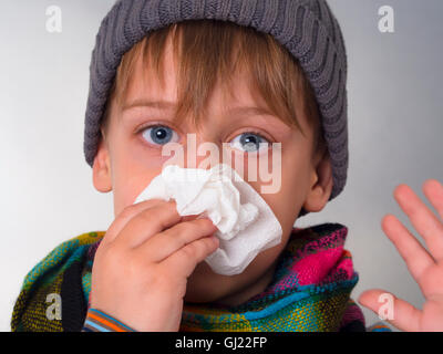 Junge seine Nase abwischen Stockfoto